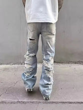 Men’s full size washed wide-leg jeans in light-wash denim with extensive distressed rips and frayed edges