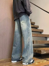 Men’s full size washed wide leg jeans in light-wash denim with relaxed fit and visible stitching details