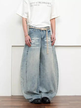 Men’s full size washed wide-leg jeans in light-wash denim with a relaxed balloon silhouette and a beige belt