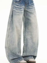 Men’s full size washed wide leg jeans in light-wash denim with subtle fading patterns and a wide leg cut