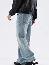 Men’s light-wash denim jeans with a relaxed fit and washed wide leg silhouette featuring classic back pockets