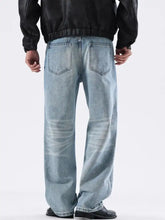 Men’s light-wash denim jeans with a relaxed fit and washed wide leg cut featuring subtle fading