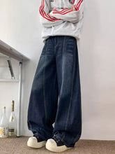 Men’s full size dark blue wide leg barrel jeans with prominent stitching and relaxed fit in denim material