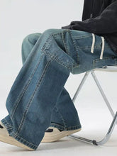 Men’s blue denim full size wide leg cargo jeans with relaxed fit and prominent cargo pockets front view