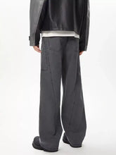 Men’s full size wide leg cargo jeans in dark gray with a relaxed utilitarian design and visible stitching details