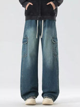 Men’s full size wide leg cargo jeans in faded blue denim with large pockets and white drawstring waist