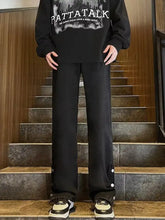 Men’s full size black wide-leg casual jeans with white button accents on side seams ideal for casual wear