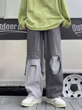 Men’s full size wide leg distressed jeans in grey denim with ripped knee patches and a relaxed wide leg cut