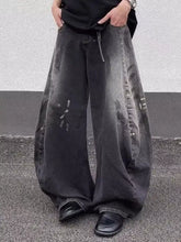 Men’s full size wide leg distressed black jeans with faded patches and chain detail on the side seam