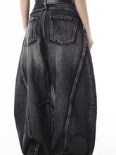 Men’s full size wide-leg distressed jeans in black denim with a relaxed fit and visible stitching details