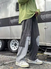 Men’s dark gray patchwork denim full size wide leg distressed jeans with contrasting light gray panels and distressing