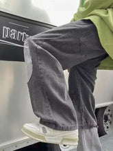 Men’s dark gray denim full size wide leg distressed jeans with patchwork design and frayed cuffs
