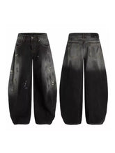 Men’s full size black denim wide leg distressed jeans with tapered silhouette and ombre fade effect