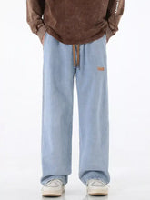 Men’s light blue wide-leg denim drawstring jeans with brown leather accents featuring a comfortable leg drawstring waist