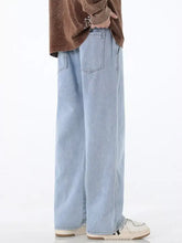 Men’s light-wash denim drawstring jeans with a relaxed wide-leg cut and classic front pockets for comfort