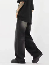 Men’s black wide leg denim jeans with faded gradient wash and subtle stitching details in full size wide leg fit