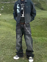 Men’s black distressed denim jacket with graphic print paired with full size wide leg jeans plus size