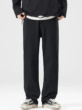 Men’s full size wide leg jeans in black tapered pants with relaxed fit and subtle drawstring waistband