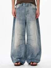 Men’s full size wide leg jeans in faded blue denim with subtle distressing details for a stylish casual look