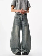 Men’s full size wide leg jeans in faded blue denim with front pockets and a black belt with silver buckle