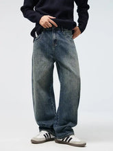 Men’s full size wide leg jeans in faded medium-blue denim with subtle whiskering and reinforced stitching