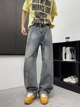 Men’s full size wide-leg gray denim jeans with distressed faded wash and subtle white paint splatter details