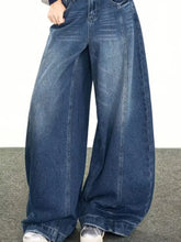 Men’s full size wide leg jeans in medium-wash blue denim featuring classic stitching and a relaxed fit