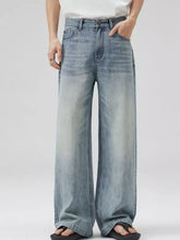 Men’s full size wide leg jeans in light-wash denim with subtle fading showcasing wide leg jeans style