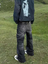 Men’s full size wide leg black denim jeans with distressed faded wash and silver chain attached to belt loop