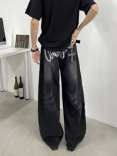 Men’s full size wide leg black denim jeans with faded distressed look and embroidered cross detailing on back pockets perfect fit