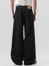 Men’s black wide leg denim jeans with faded texture and tan leather patch at waistband full size plus size