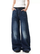 Men’s full size wide-leg jeans in dark blue denim with a faded, distressed look and visible stitching