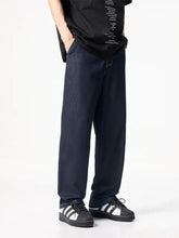 Men’s full size wide leg dark blue denim jeans with a relaxed straight-leg cut made from durable material