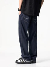 Men’s full size wide leg dark blue denim jeans with white stitching and a relaxed straight-leg cut