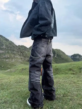 Men’s full size wide leg jeans in dark-wash denim with a distressed look and chain on the back pocket showing back side
