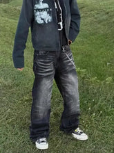 Men’s full size wide leg jeans in dark wash denim with distressed detailing and visible fading along the thighs