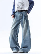 Men’s full size wide leg jeans in faded blue denim with visible stitching and slightly stretchy fabric for comfort