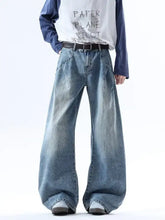 Men’s full size wide leg jeans in faded blue wash with raw hem and slightly stretchy fabric for comfortable wear