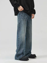 Men’s full size wide leg jeans in faded blue denim with subtle distressing and raw hem for a perfect fit wide leg style