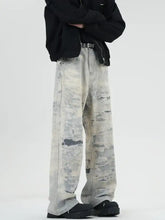 Men’s full size wide leg jeans with faded distressed gray and white camouflage denim material