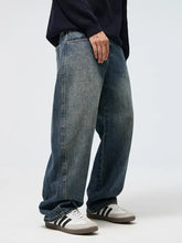 Men’s full size wide leg jeans plus size in faded medium-blue denim with visible stitching and relaxed straight cut silhouette