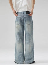 Men’s full size light-wash denim wide leg jeans with faded distressed detailing and a wide leg cut