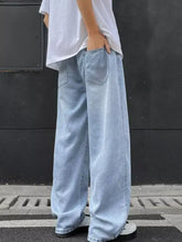 Men’s full size wide leg jeans in light-wash denim with a relaxed straight-cut silhouette and classic front pockets