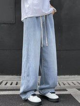 Men’s full size wide leg light-wash denim jeans with drawstring waist and subtle fading in a plus size fit