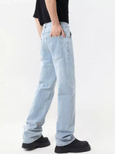 Men’s full size wide leg jeans in light-wash denim with a relaxed straight-leg cut and visible stitching details