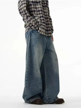 Men’s full size wide leg jeans in medium-wash blue denim with subtle fading and distressing details