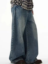 Men’s full size wide leg jeans in medium-wash blue denim featuring a relaxed fit and classic stitching design