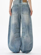 Men’s full size wide leg jeans in faded blue denim with distressing and seam detailing