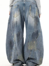 Men’s full size wide leg jeans made of denim with a faded distressed blue wash and visible stitching details