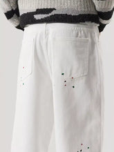Men’s plus size wide leg white trousers with colorful paint splatters made from premium cotton fabric